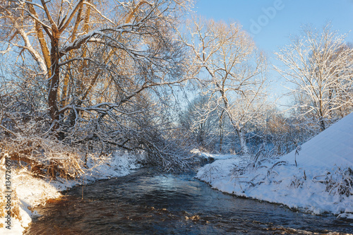 Winter park with snow trail and river at sun day © Eduard Panichev