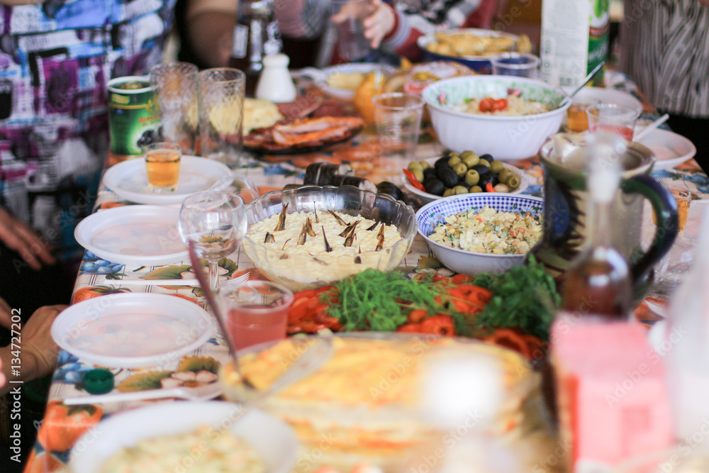 banquet with salads and alcohol drinks in the village