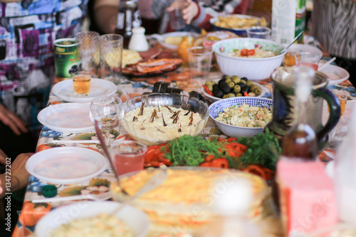 banquet with salads and alcohol drinks in the village