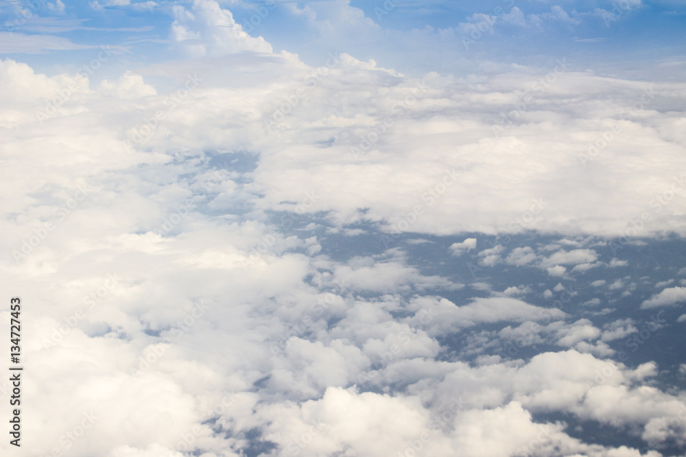 Beautiful cloudscape from sky aerial view. Beauty of nature view from above the sky and clouds. White clouds and blue sky view from airplane window. Sunlight in the sky shines on clouds. Beautiful cloudscape from sky aerial view. Beauty of nature view from above the sky and clouds. White clouds and blue sky view from airplane window. Sunlight in the sky shines on clouds.