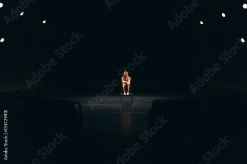 female actress alone on stage photo