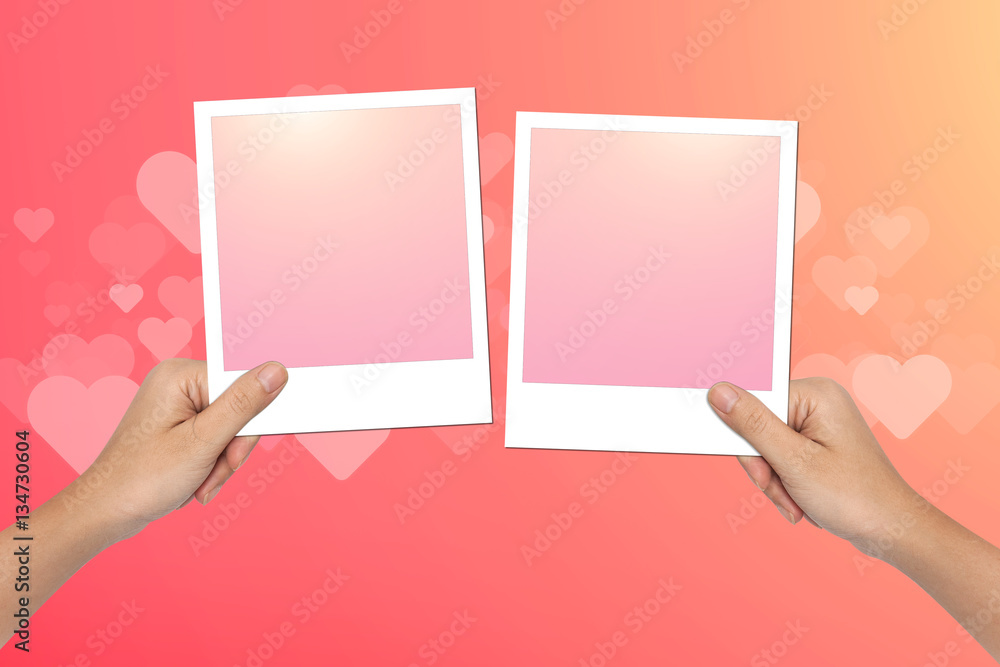 Hands hold Blank photo frame on pink Valentines Day Background Hands hold Blank photo frame on pink Valentines Day Background