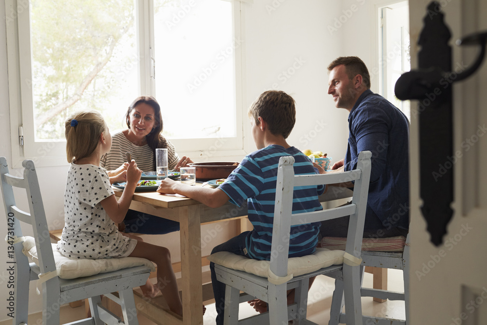 Family At Home In Eating Meal Together Family At Home In Eating Meal Together