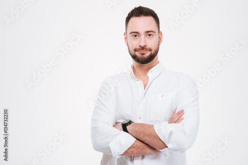Handsome bearded man posing with arms crossed