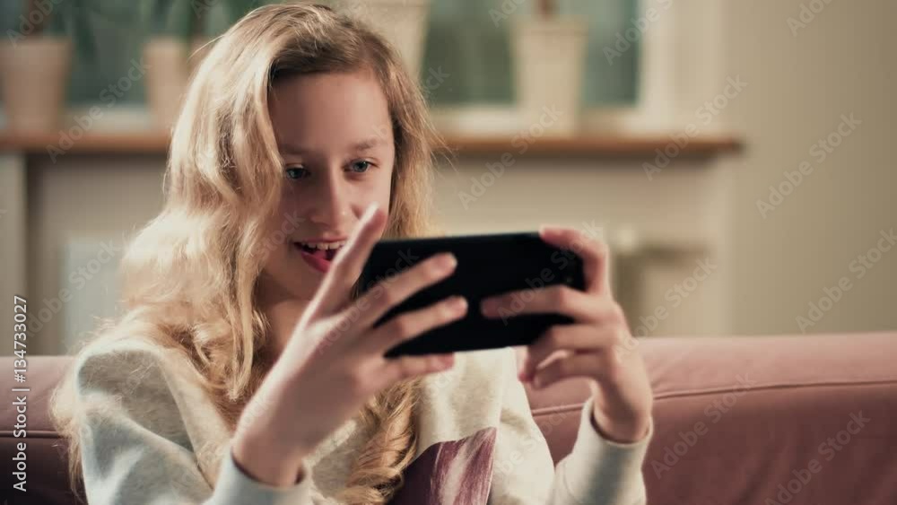 Child playing new smartphone app game Child playing new smartphone app game