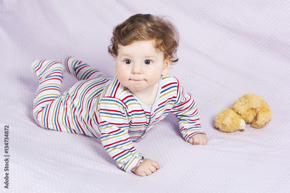 The little boy in the crib with toys. The child in the home
The little boy in the crib with toys. The child in the home