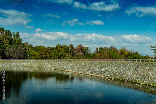 Lake and road on blue sky background