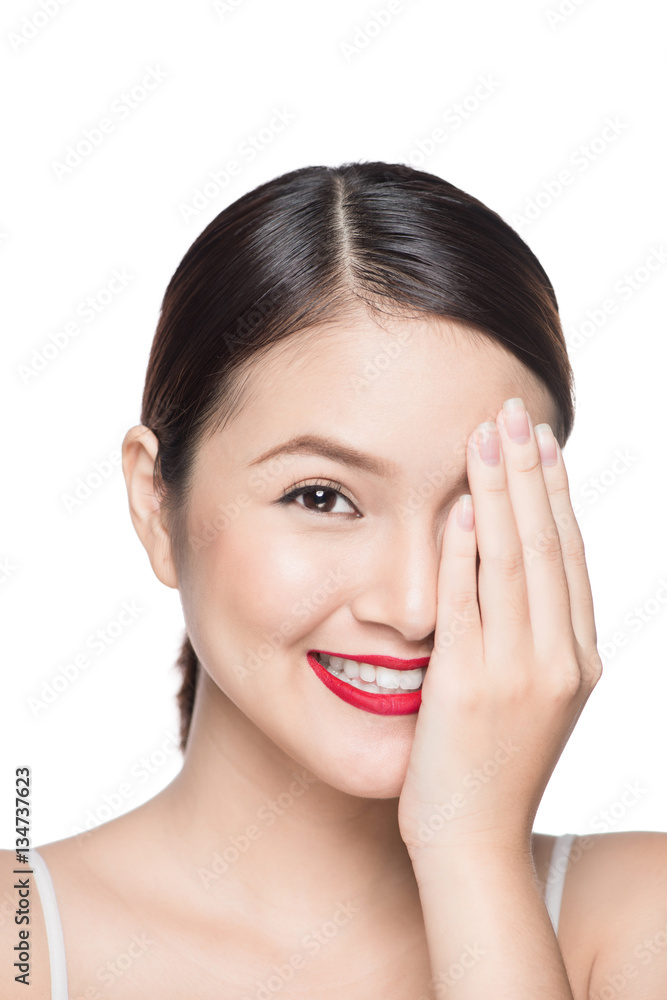 Portrait of young asian woman looking shy hiding behind her hand