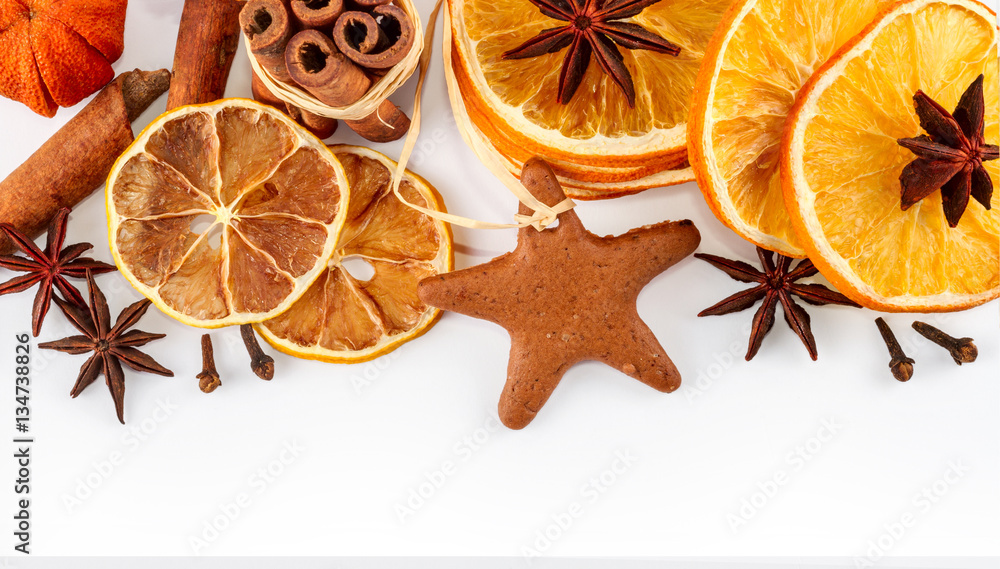 border of dried oranges, lemons, mandarins, star anise, cinnamon sticks and gingerbread, isolated on white background border of dried oranges, lemons, mandarins, star anise, cinnamon sticks and gingerbread, isolated on white background