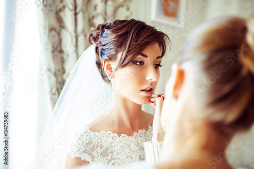 The makeup artist doing a make up for bride