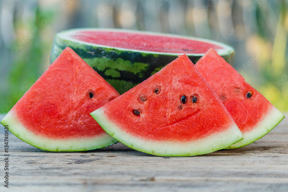 water melon slice on wood texture in nature background. water melon slice on wood texture in nature background.