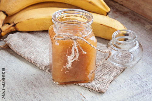 Bananas jam in a glass jar selective focus
