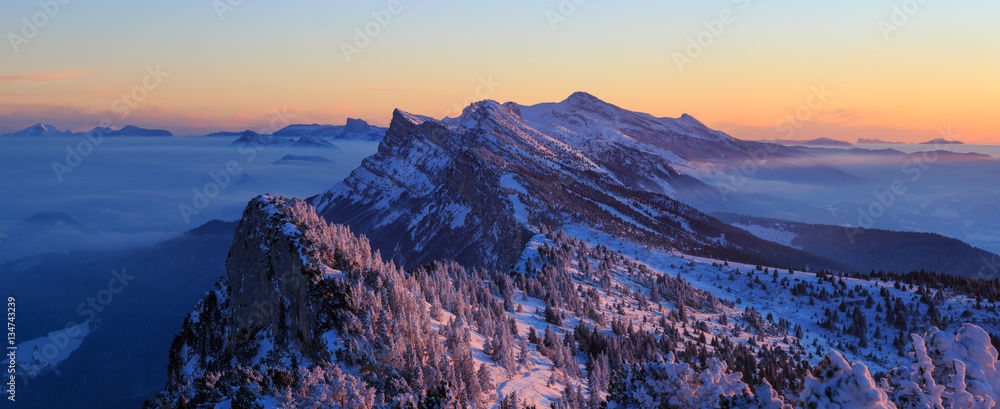 Fototapeta premium Snow covered mountainrange, Vercors, France, during a winter sunrise.