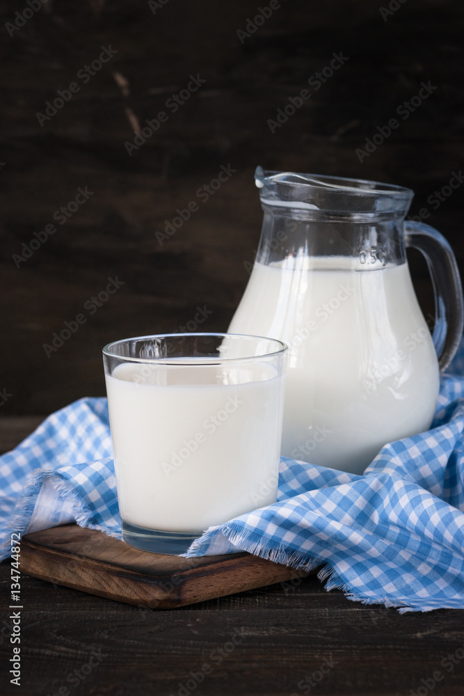 Dairy products. Milk in glass and in jug Dairy products. Milk in glass and in jug