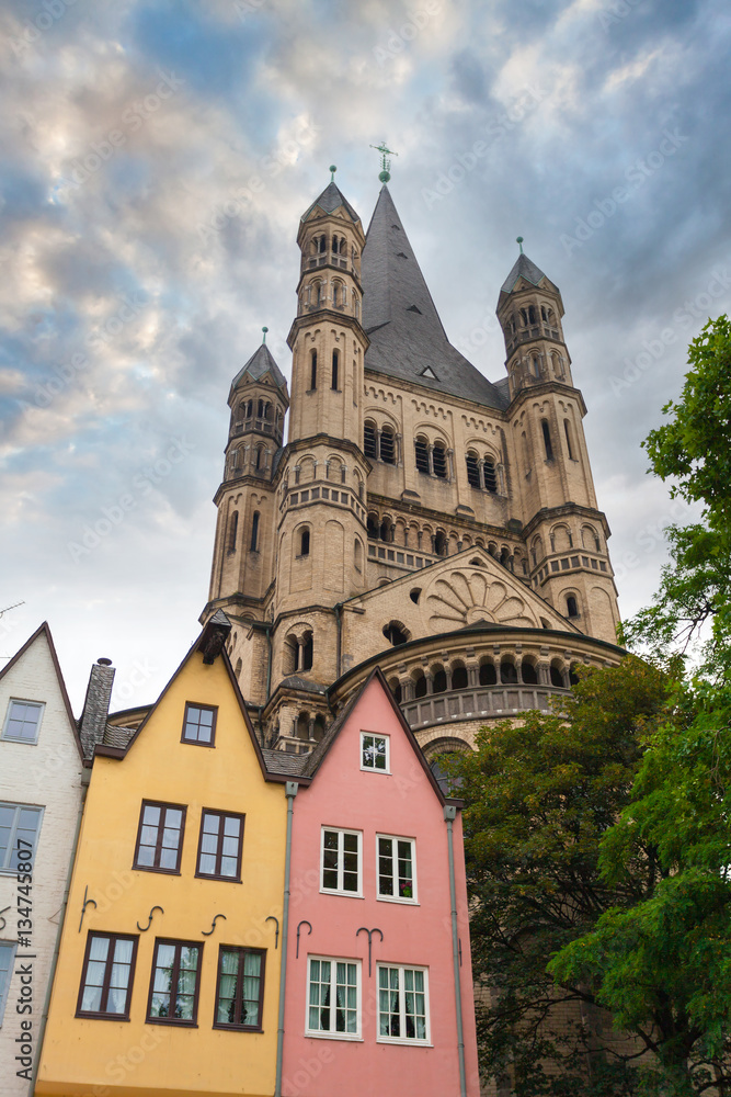 Great St. Martin Church and colorful houses in Bavarian style of Cologne. Cologne, North Rhine-Westphalia, Germany.