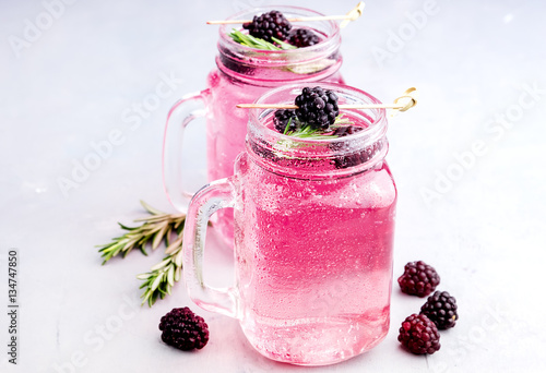 Tasty cold blackberry lemonade with rosemary