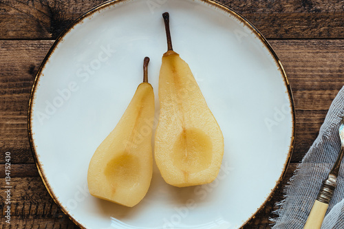 Healthy Snack of Poached Pear on White Plate photo