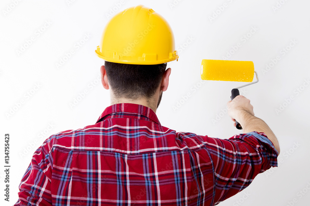 man working painting the wall man working painting the wall