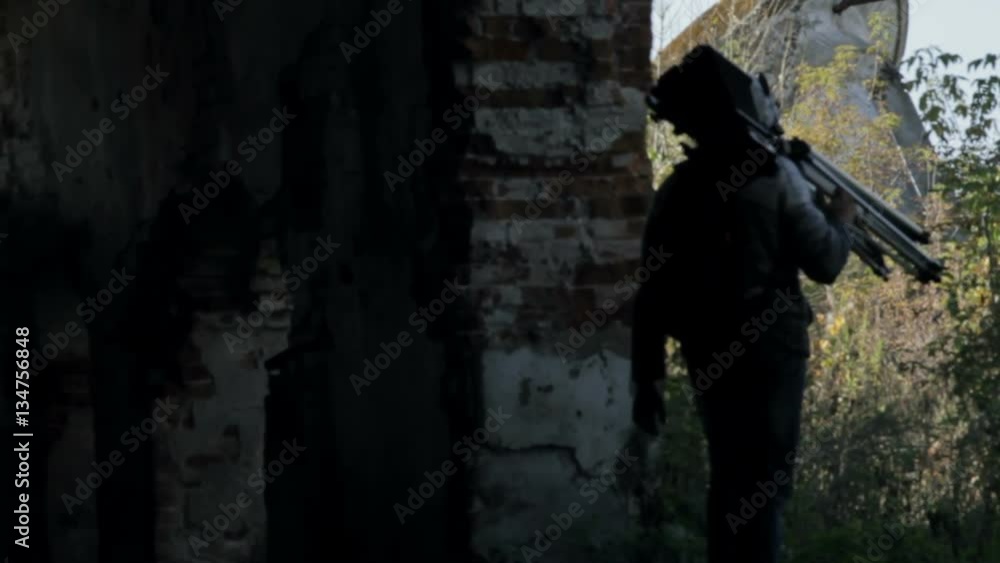 Man walks with an old retro camera among the ruins Man walks with an old retro camera among the ruins