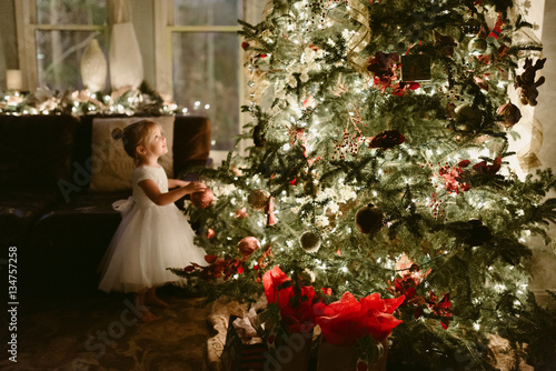 Young girl beside christmas tree 