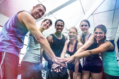 Fototapeta Naklejka Na Ścianę i Meble -  Fit people putting their hands together