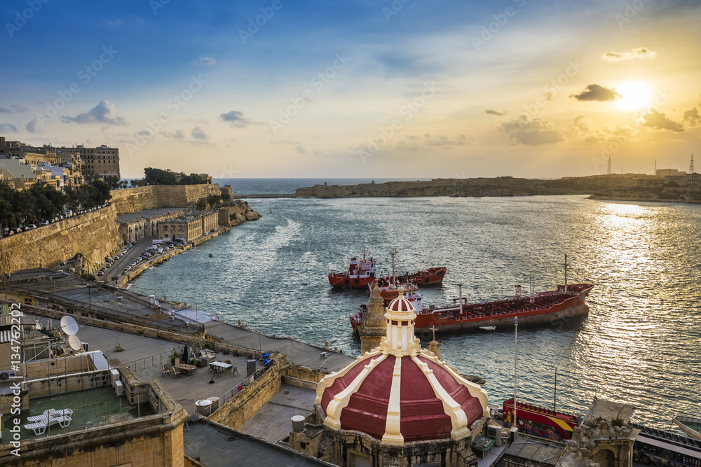 Valletta, Malta - Sunrise at the Grand Harbor of Valletta, the capital city of Malta with blue sky and ships 