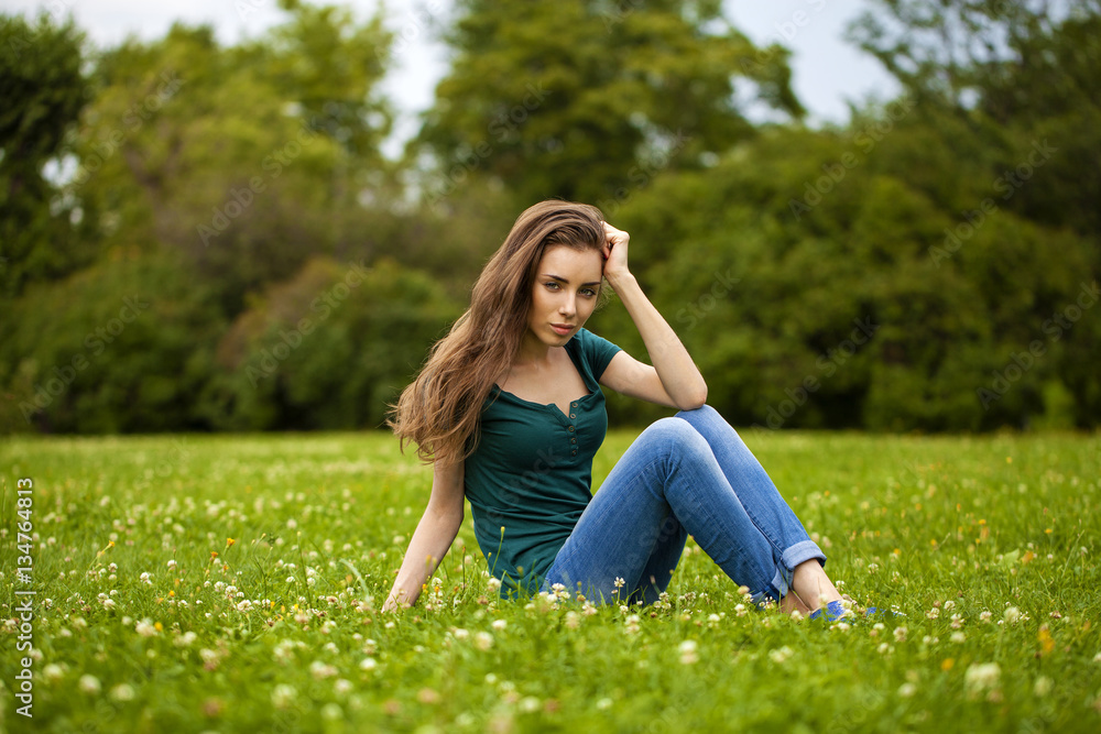 Young beautiful brown haired woman in blue jeans Young beautiful brown haired woman in blue jeans