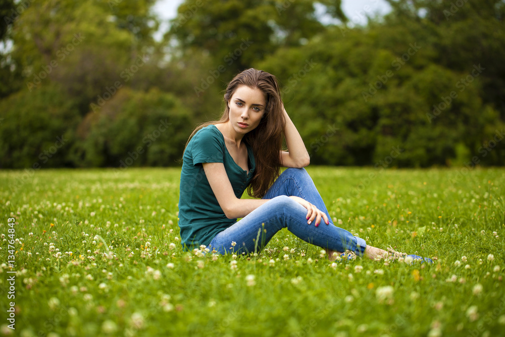 Young beautiful brown haired woman in blue jeans Young beautiful brown haired woman in blue jeans