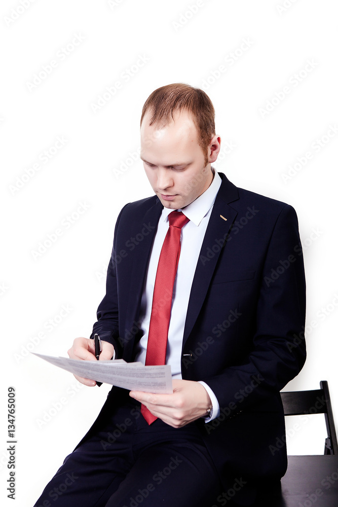 Portrait of a smiling middle aged business man holding a small binder with both hands. Vertical format isolated on white. Portrait of a smiling middle aged business man holding a small binder with both hands. Vertical format isolated on white.