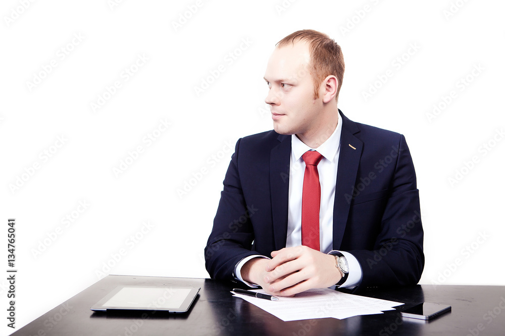 Businessman at a table with tablet before signing the contract Businessman at a table with tablet before signing the contract