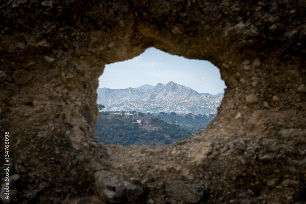 mountains through a hole in the wall