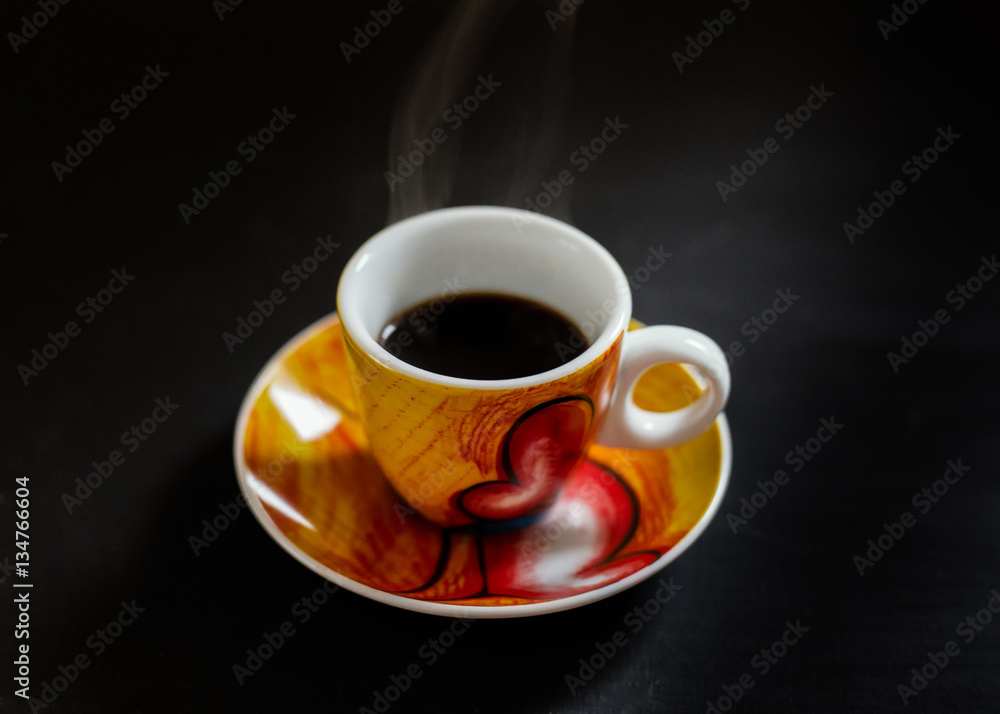 A cup of coffee on black background