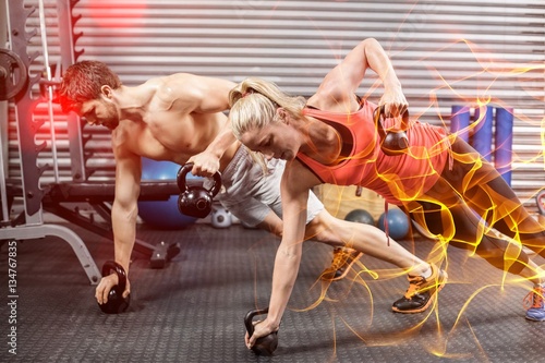 Couple doing push up with dumbbells 