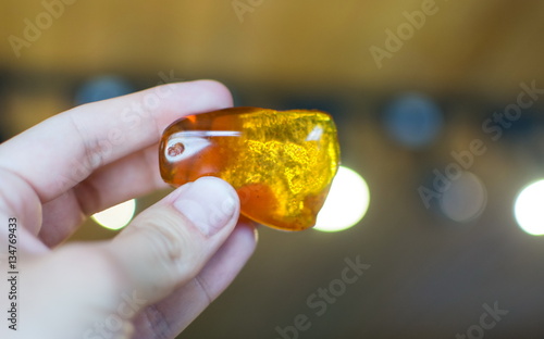 Hand holding amber stone