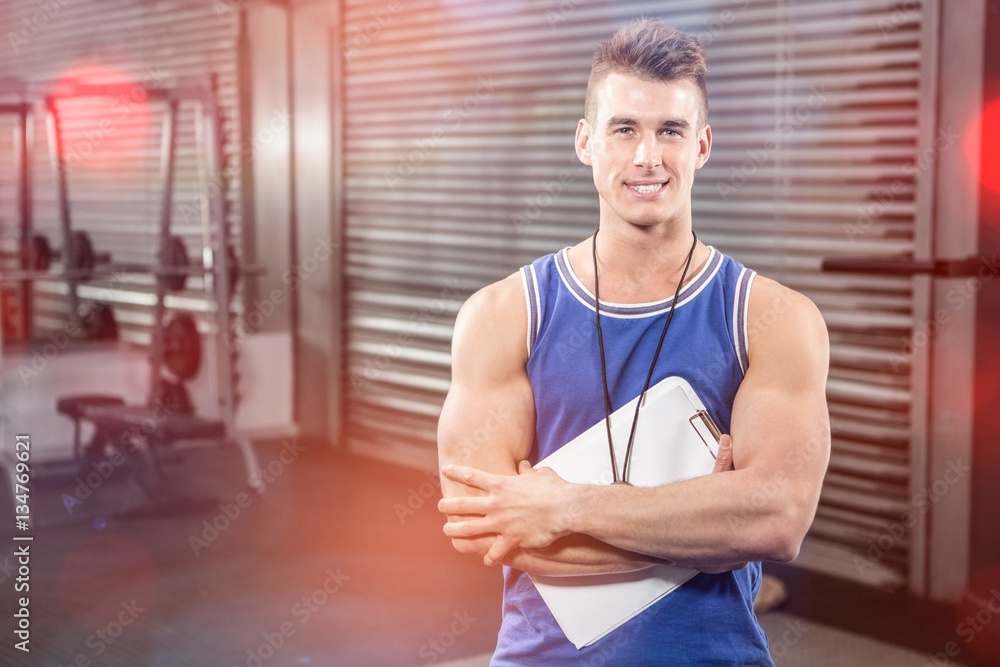 Fototapeta premium Portrait of confident trainer standing with clipboard
