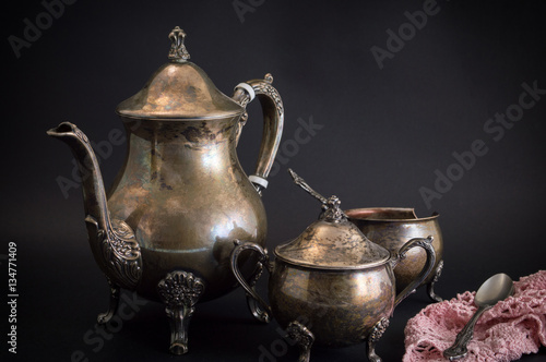 Old silver kitchen utensils on black