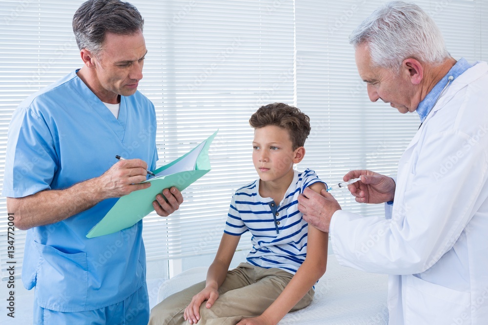 Doctor giving an injection to the patient Doctor giving an injection to the patient