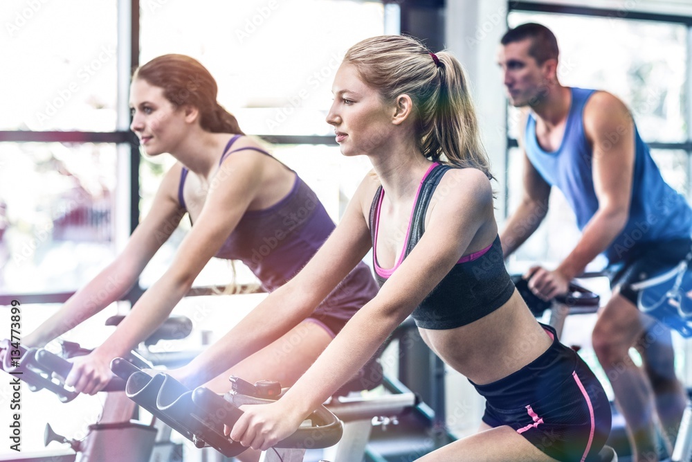 Fit people working out at spinning class Fit people working out at spinning class