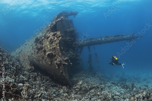 Scuba diver swimming near shipwreck