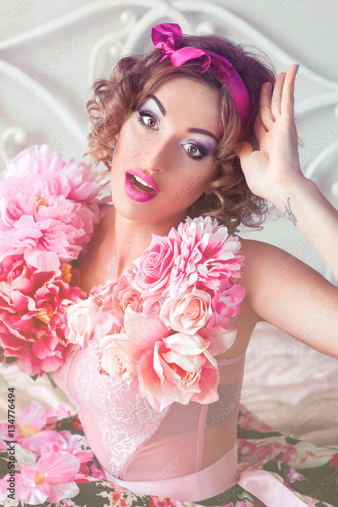 Naklejka premium portrait of young beautiful woman in colorful dress with flowers it in doll style with ara on her shoulder