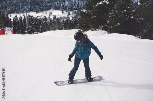 Woman snowboarder on the slopes of the resort on a winter day.