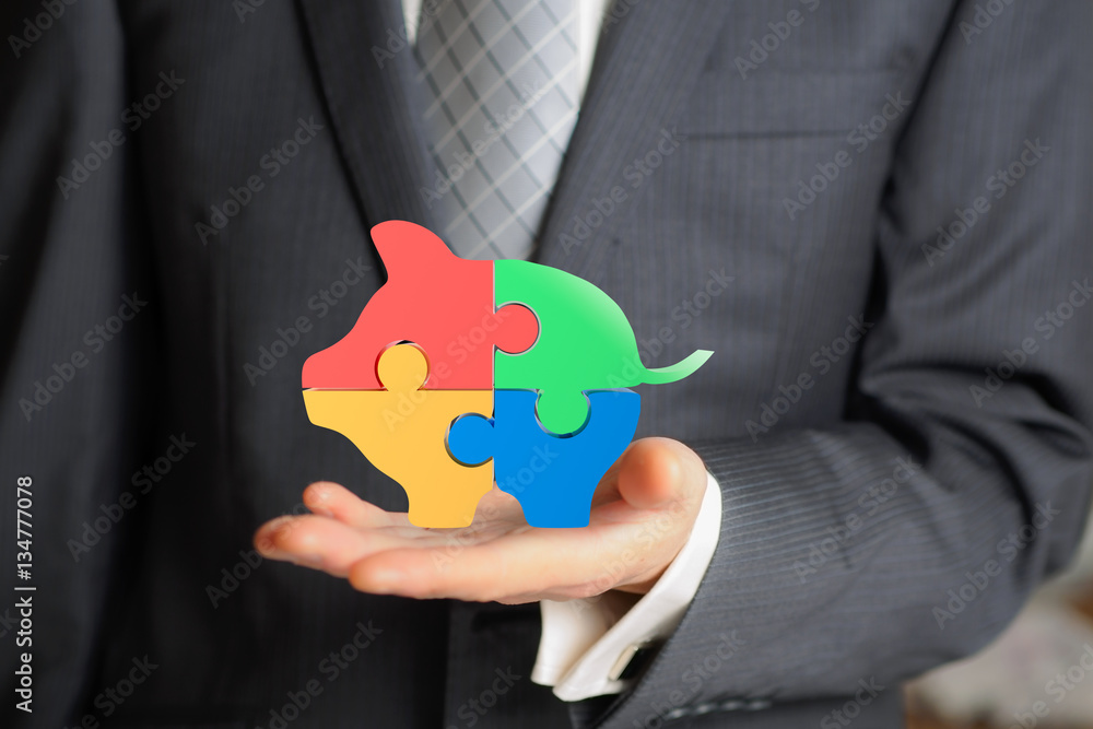 business man hold a puzzles of piggy bank business man hold a puzzles of piggy bank