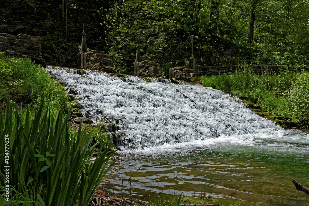 Fototapeta premium The Siewer’s Spring waterfall is a terraced waterfall that is a popular tourist attraction. Fishermen can often be found lining the banks.