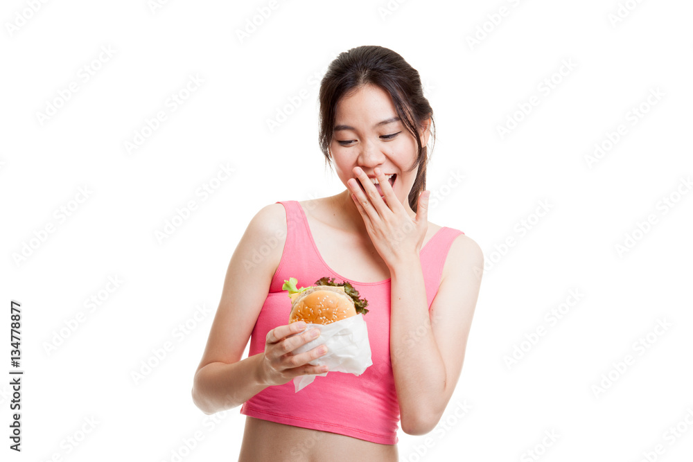 Beautiful Asian healthy girl enjoy eating  hamburger.