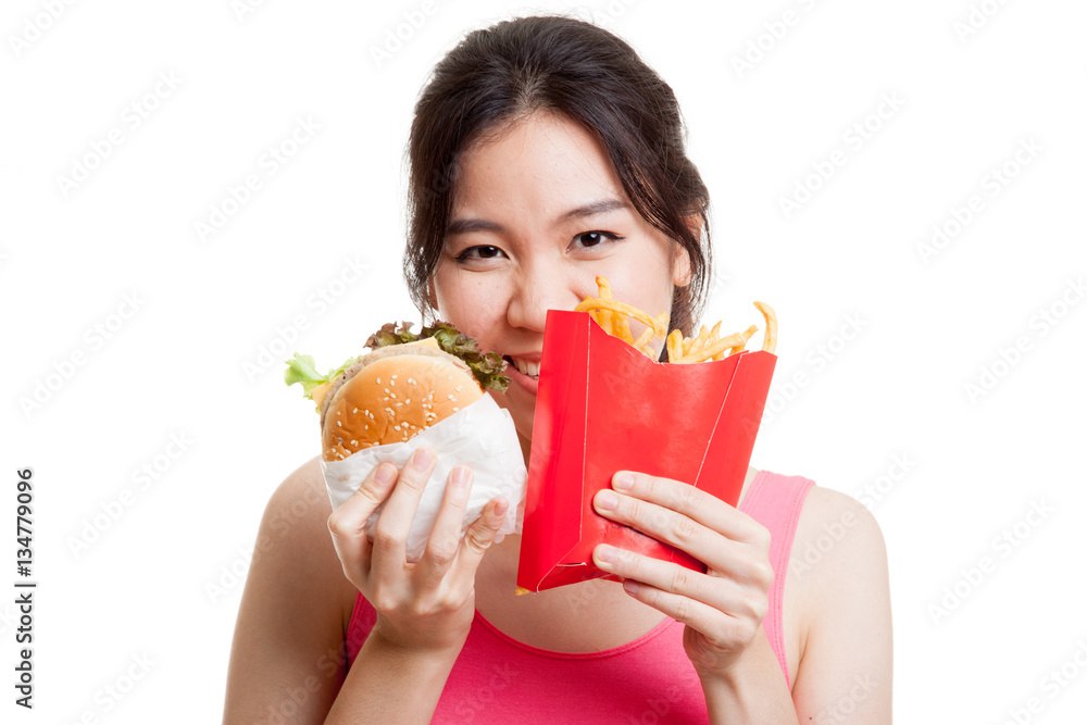 Beautiful Asian healthy girl with french fries and hamburger. Beautiful Asian healthy girl with french fries and hamburger.