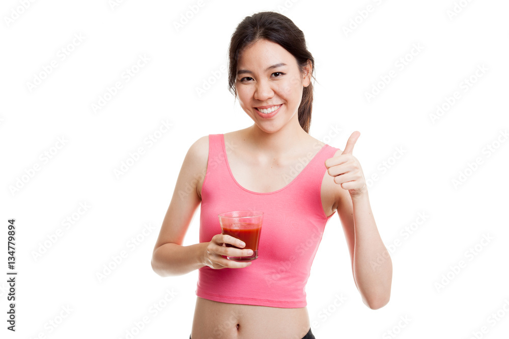 Beautiful healthy Asian girl thumbs up with tomato juice. Beautiful healthy Asian girl thumbs up with tomato juice.