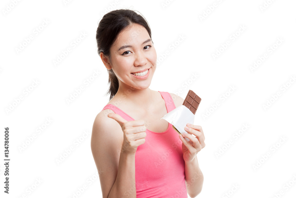 Beautiful healthy Asian girl thumbs up with chocolate. Beautiful healthy Asian girl thumbs up with chocolate.