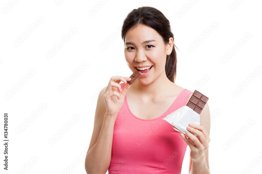 Beautiful healthy Asian girl eat chocolate. Beautiful healthy Asian girl eat chocolate.