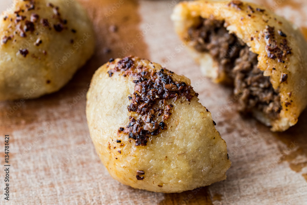 icli kofte / Boiled kibbeh / Quibe with butter sauce. icli kofte / Boiled kibbeh / Quibe with butter sauce.