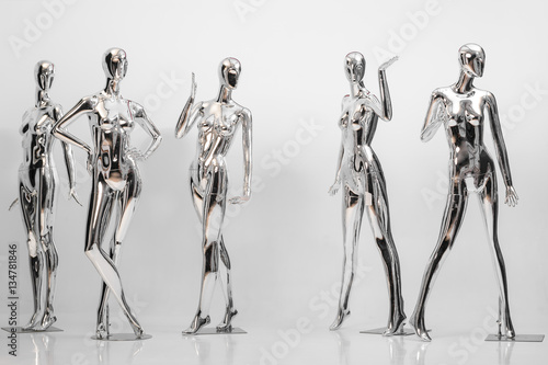 many fashion shiny female mannequins for clothes. Metallic manne photo